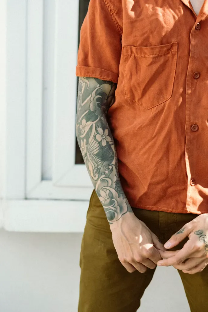 Japanese-inspired botanical waves sleeve tattoo
