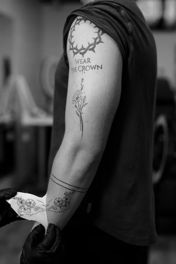 Botanical illustration and lettering tattoo