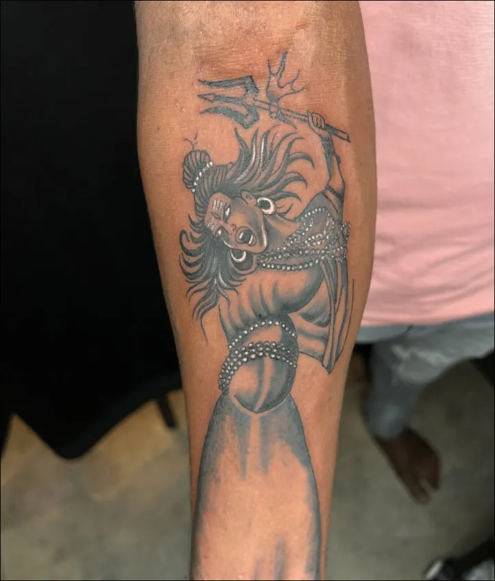 Lord Shiva with trident in motion blackwork tattoo